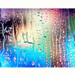 close up of rain on a window with colorful lights behind regular print