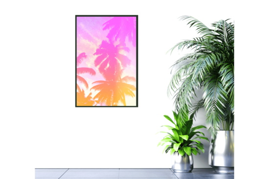 picture of palm trees with pink and orange tint picture hanging on wall