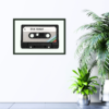 old cassette tape with "Our Songs" written on it, green background, print hanging on wall