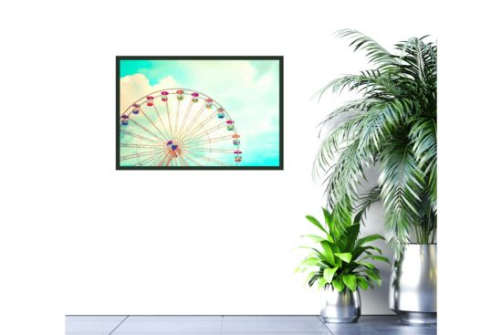 Colorful Ferris wheel against light blue sky picture hanging on wall