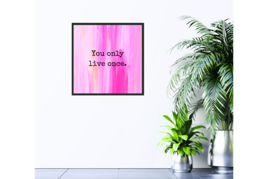 Pink abstract art with You Only Live Once inspirational quote picture hanging on wall