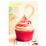red, pink, and white cupcake with pink and white coffee mug in background
