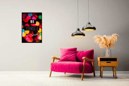 Be Yourself motivational quote with colorful city lights background print on wall next to pink chair and black lights
