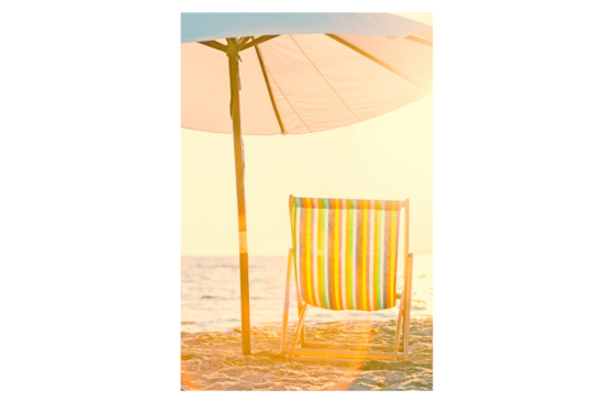 Vintage beach scene with white umbrella and striped chair wall print