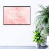 Palm Beach text with light pink feather background print hanging on wall