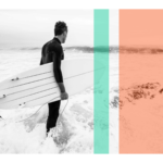 Black and white of surfer on beach holding surfboard with orange and teal stripe overlays wall print