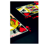 Jack, queen, and king of hearts playing cards in bright yellow and red wall print