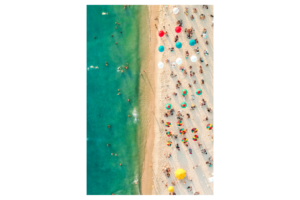 View of beach from above, lots of colorful umbrellas and people, wall print