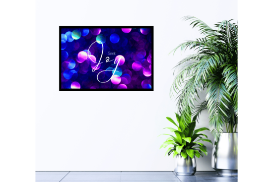 Seek Joy quote with purple, blue, and pink city lights background print on wall